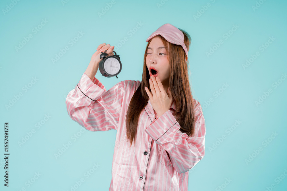 Fototapeta premium Asian Awake Wake Up Morning Sleep Tired Watch Lady Woman, A Pretty Young Female Holding Alarm Clock with Sleepy Expression, Late Night Vibes and Countdown to a New Day