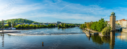 A view over the weir on the Vltava river from the Legion Bridge in Prague in springtime