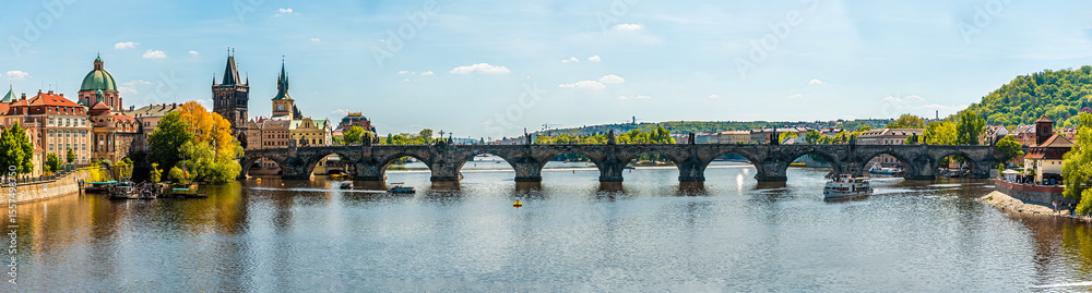 Fototapeta premium A panorama view from the west bank of the Vltava river towards the Charles Bridge in Prague in springtime