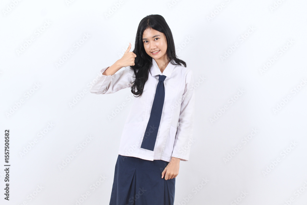Asian teenage girl student wearing a white shirt and blue skirt is giving two thumbs up. Asian teenage girl student wearing a white shirt and blue skirt is giving two thumbs up.