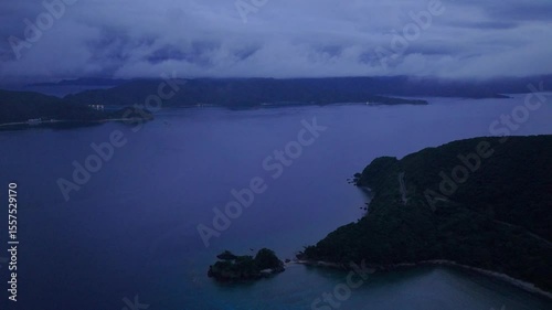 Blue hour clouds and fog with coastal landscape, twilight aerial view