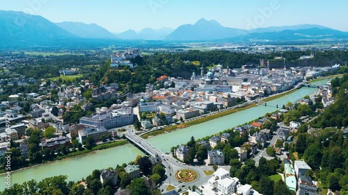 Salzburg, Austria, aerial view of the historic old town with Hohensalzburg Fortress, Salzach River, baroque architecture and surrounding Alps. Captured on a sunny summer day from a drone