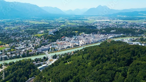 Salzburg, Austria, aerial view of the historic old town with Hohensalzburg Fortress, Salzach River, baroque architecture and surrounding Alps. Captured on a sunny summer day from a drone
