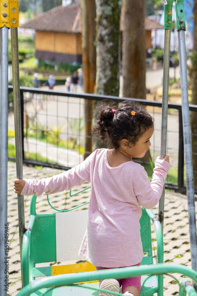 Obraz premium Daughter playing in backyard playground