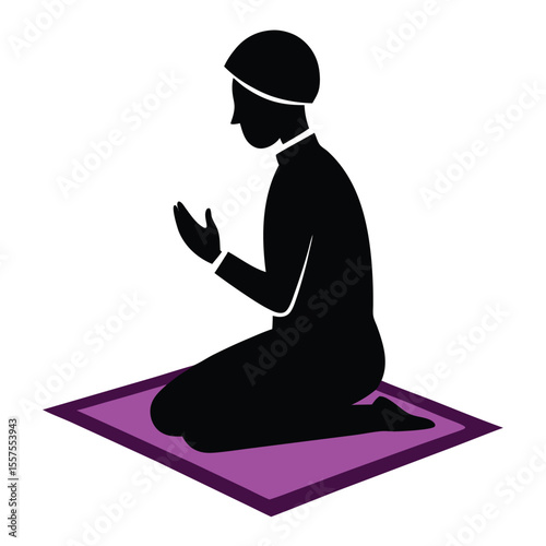 Silhouette of a Muslim Man Kneeling in Prayer on a Prayer Mat