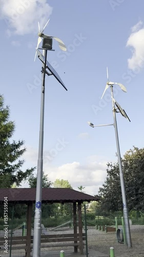 Renewable energy sources with wind turbines and solar panels in a green park setting