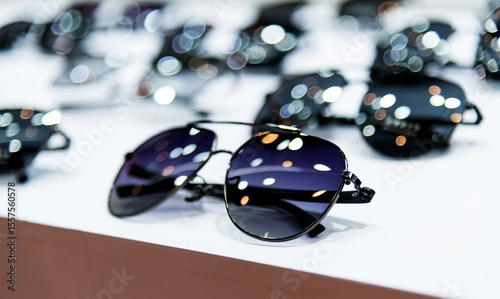 Many sunglasses are displayed in the store