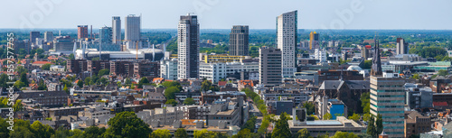 Photography Aerial view of Eindhoven, Netherlands, showing Philips Stadium, Vesteda Tower, Admirant, modern and traditional architecture, greenery, and a flat horizon