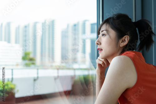 Businesswoman looking away by the window Free Download Businesswoman looking away by the window - GFXLoad
