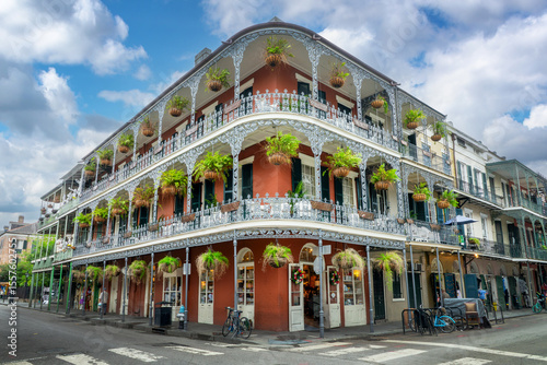 NOLA architecture, brick wall building with balconies and intricate ironwork columns in a street of the French Quarter, New Orleans, Louisiana