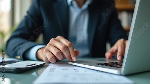 A hyper-realistic image captures a businessman intently using a laptop, calculating income to pay taxes to the government. It emphasizes the process of filling an online tax return form for payment