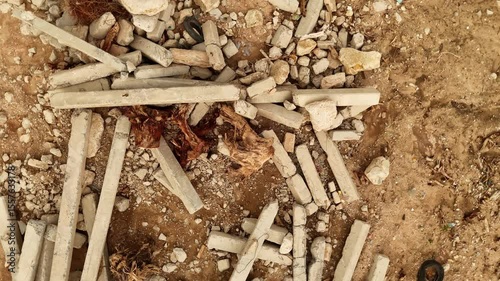 Construction debris scattered in a unique way on the sandy soil forming intriguing patterns