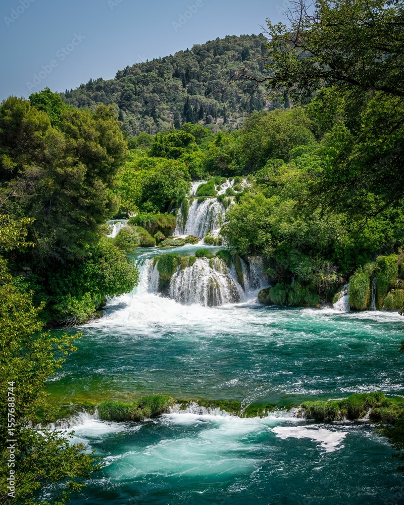 Fototapeta premium Lush waterfall and turquoise river landscape