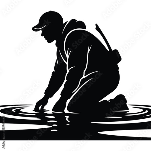 Silhouette of a Man Kneeling by the Water's Edge
