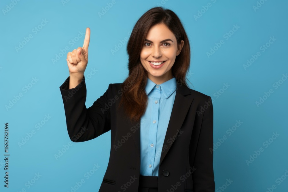 Studio portrait of a businesswoman pointing upwards with her index finger Studio portrait of a businesswoman pointing upwards with her index finger