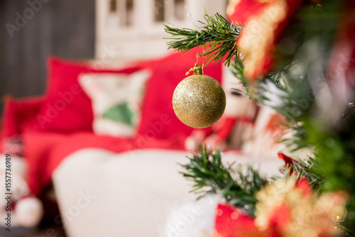 A golden and white ornament hangs on a Christmas tree. the ornaments are hanging from the branches. winter holidays,snowflake, beautiful decoration for home.Christmas decorations
