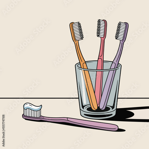Three colorful toothbrushes in a glass with one toothbrush with toothpaste