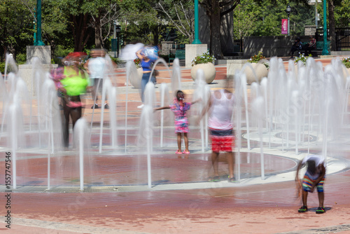 Motion blur several kids playing in Centennial Olympic Park fountain