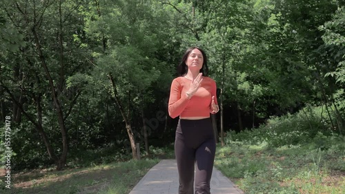 Woman Jogging on Forest Trail in Morning Light, Healthy lifestyle and mindfulness in green natural environment