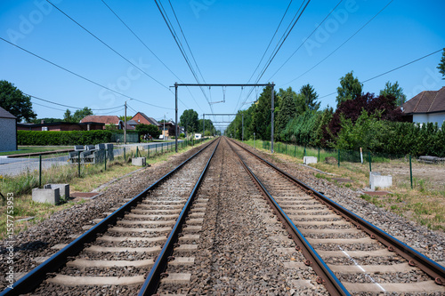 Perspective view over double railway track at the Flemish countryside in Heist Op Den Berg, Antwerp Province, Belgium