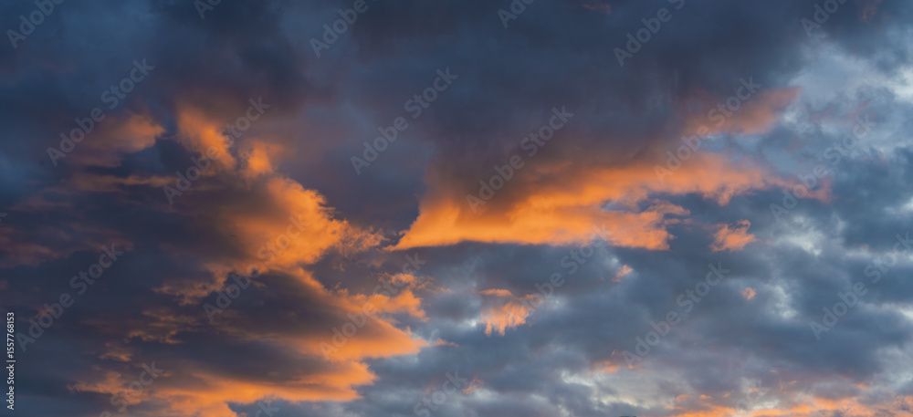 Fototapeta premium A Dramatic Sunset Reveals Beautiful Clouds Filled with Vibrant and Rich Hues in the Sky
