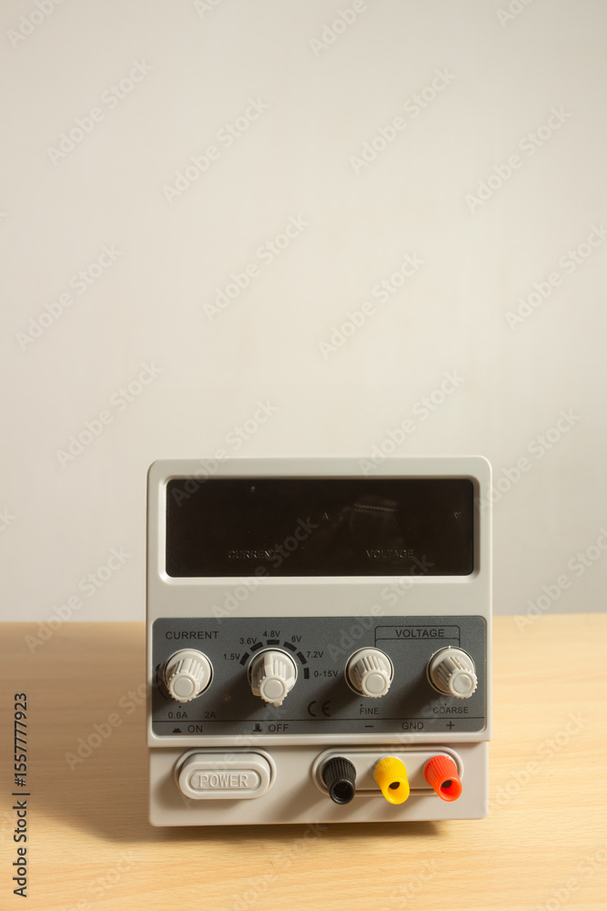 Fototapeta premium digital DC power supply unit wooden table