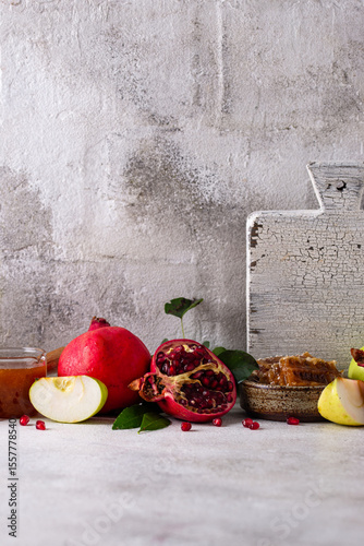Rosh Hashana concept with honey, apple and pomegranate
