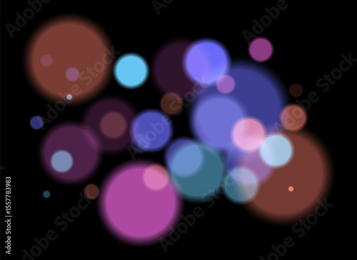 Colorful blurred circles on dark background with smooth soft edges. Overlapping glowing bokeh creates dreamy abstract depth and festive atmosphere without clear focal point.