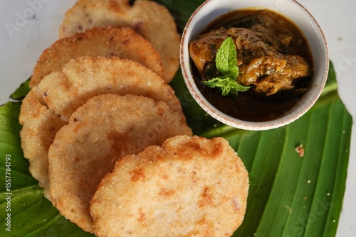 Kerala breakfast Ney pathal or pathiri  served with chicken curry- malabar Iftar foods