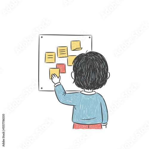 Child placing sticky notes on a board in a creative workspace  