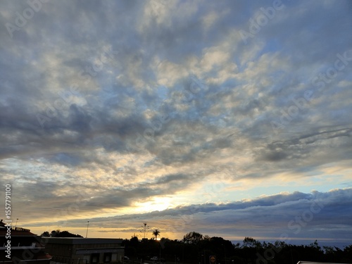 The sky is cloudy and the sun is setting
