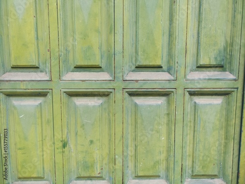 The green door has a lot of dirt on it
