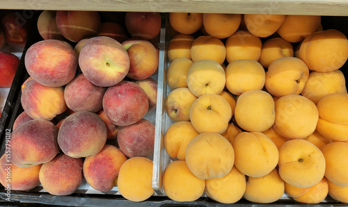 Two bins of peaches, one with red and one with yellow