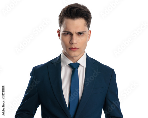upset young businessman in navy blue suit making an angry face and frowning