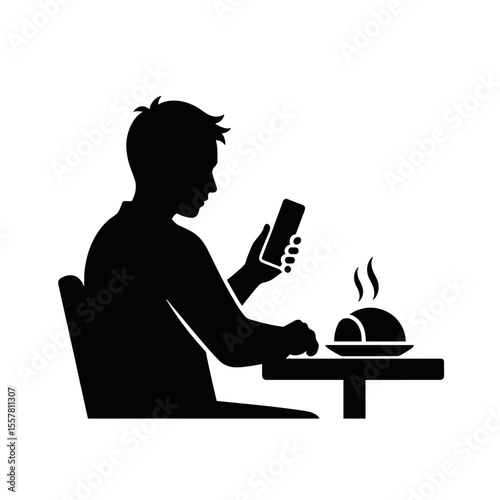 Man photographing meal with smartphone while sitting at table  
