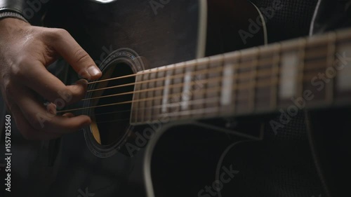 The guitarist is playing the guitar-close up
