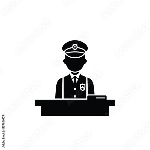 Passport control officer standing at desk wearing uniform and hat  