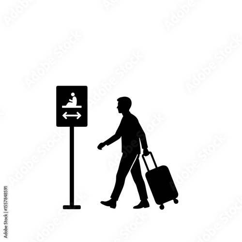Passenger walking with suitcase toward prayer room sign in airport  