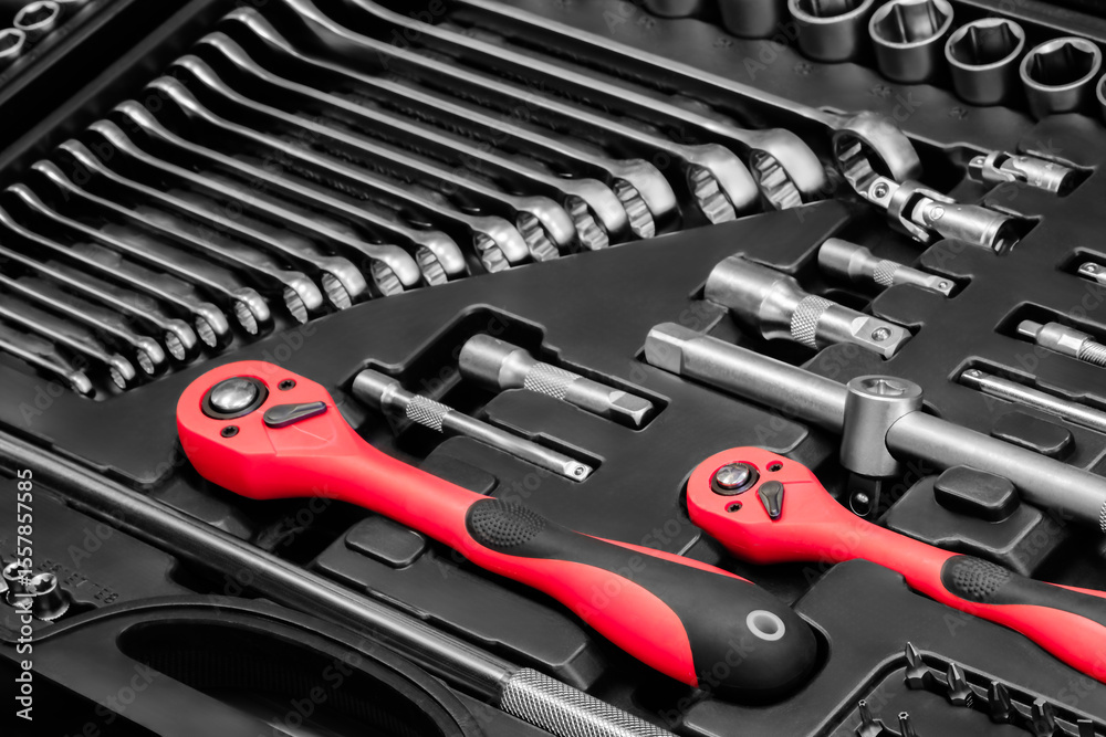 Fototapeta premium A toolbox with many different tools including pliers, wrenches, and screwdrivers. The tools are organized in a way that makes it easy to find what you need