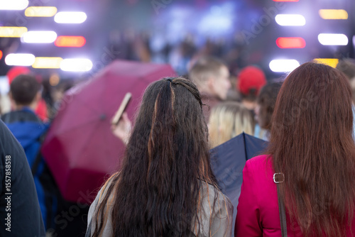 A concert on the street in the city with a large number of people.