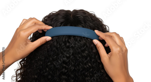 Blank hairband in curly hair, hand adjusting, isolated