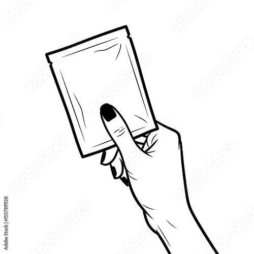 Hand holding a facial mask package, ready for skincare routine