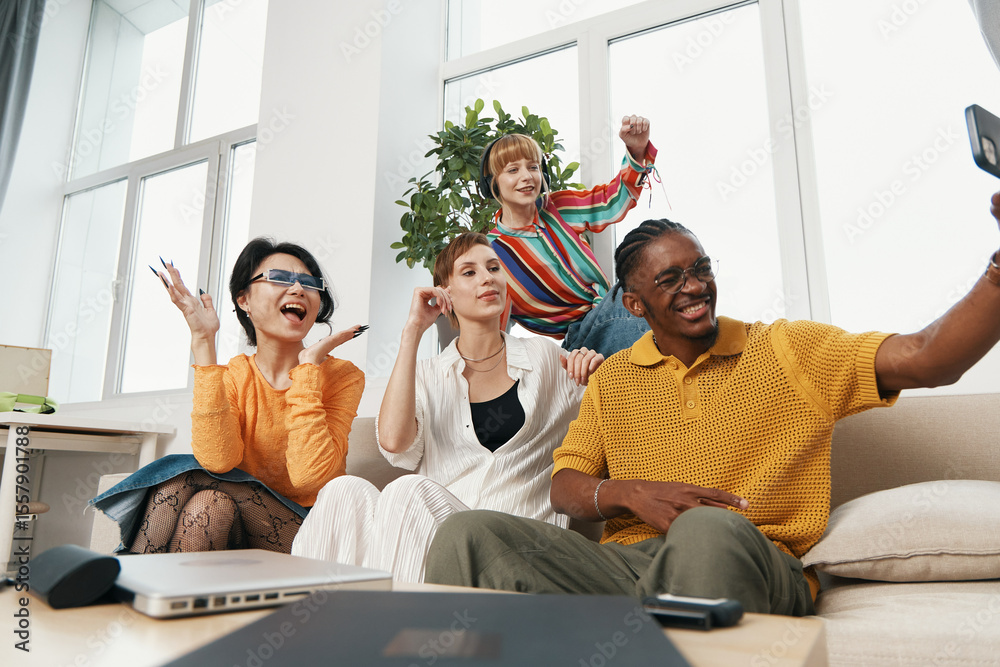 Fototapeta premium smiling young adult coworkers socializing in workplace, diverse business colleagues enjoying moment together, Gen Z friends capturing selfie indoors
