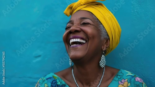 Elderly woman in a vibrant, colorful dress, laughing heartily with joy.
