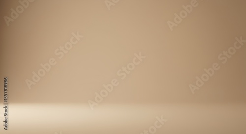 A tan-colored studio background with subtle lighting, showing a floor and wall meeting at the corner.