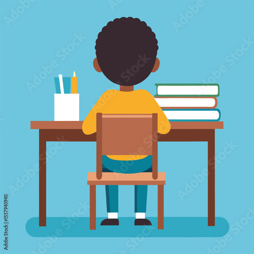 Back view of a young student focused on studying with books and stationary on a table