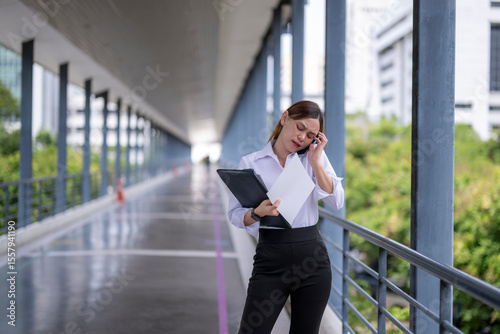 Wallpaper Mural Stressed businesswoman having a headache while making a phone call Torontodigital.ca