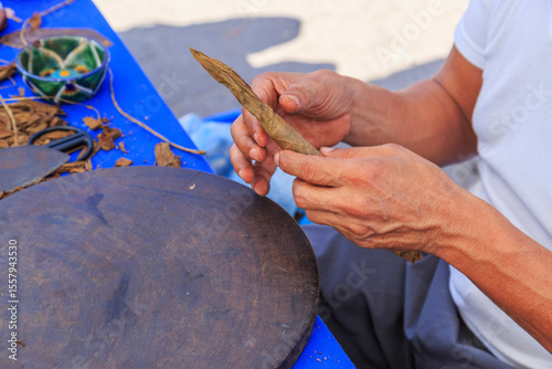 Mexico, Nayarit State, Sayulita. Hand-rolling tobacco into cigars.