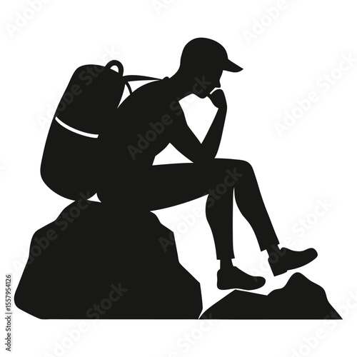Silhouette of a hiker sitting on a rock contemplating nature outdoors