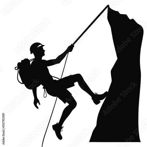 Silhouette of a rock climber descending a mountain with safety ropes and gear